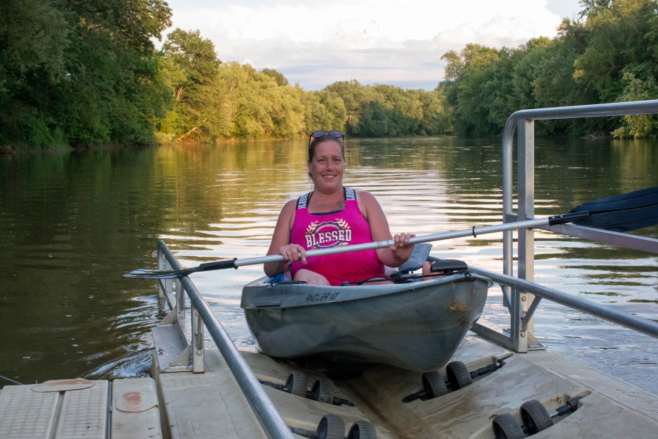 Woman using the handicap accessible boat launch at Allegany River Park