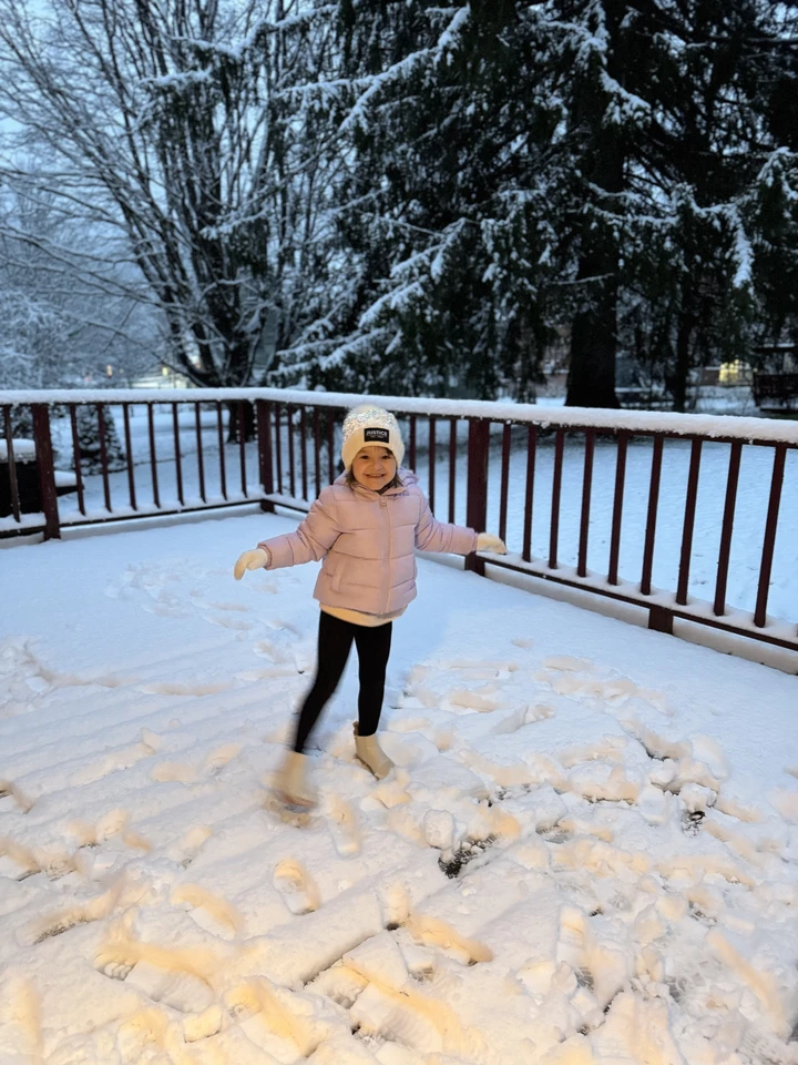 A young winter enthusiast excited for the fresh morning snowfall